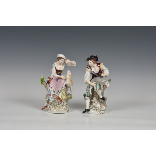 120 - A pair of Sitzendorf figures of a shepherd & shepherdess, early 20th century, both modelled sitting ... 