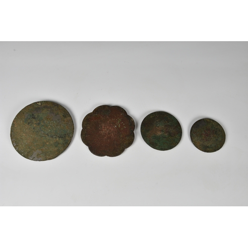 1240 - Four Chinese bronze mirrors, probably Sui or Tang Dynasty, to include three of circular shield form,... 