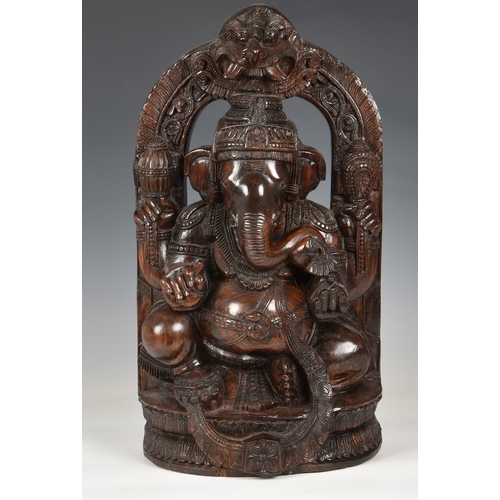 1259 - A large Indian carved hardwood figure of the Hindu deity Ganesha, 20th century, seated on a lotus ba... 