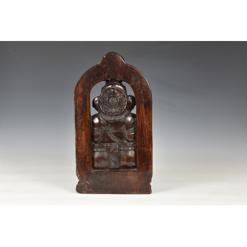 1259 - A large Indian carved hardwood figure of the Hindu deity Ganesha, 20th century, seated on a lotus ba... 