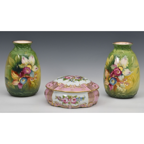 132 - A pair of Royal Bonn pottery vases, Germany, decorated with painted images of spring flowers; signed... 