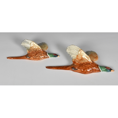 133 - A pair of Beswick Flying Pheasant wall plaques, 20th century, numbered 661/2 & 661/3. (2)