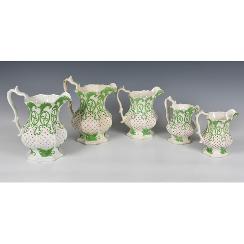 134 - A graduated set of four Victorian relief moulded jugs, of octagonal form, decorated with stylised gr... 