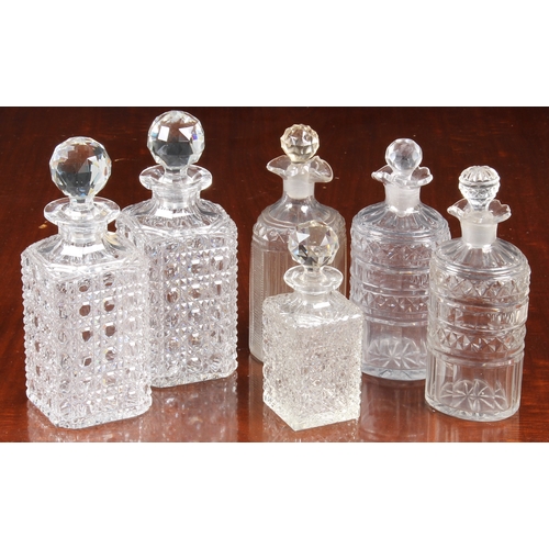 150 - A pair of Georgian oval pint decanters, with panel, diamond and prismatic cut bodies and necks with ... 