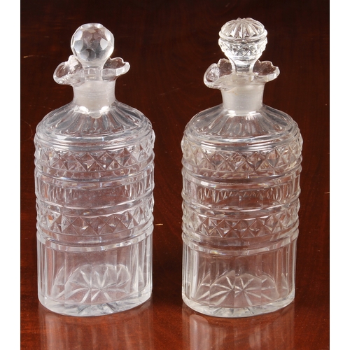 150 - A pair of Georgian oval pint decanters, with panel, diamond and prismatic cut bodies and necks with ... 