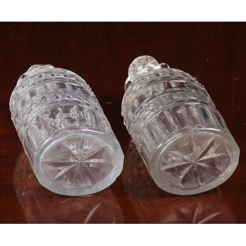 150 - A pair of Georgian oval pint decanters, with panel, diamond and prismatic cut bodies and necks with ... 