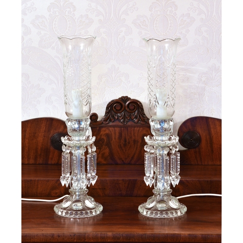 155 - A pair of Baccarat style glass lustre storm lamps, 1980s-90s, the moulded glass candlestick base wit... 