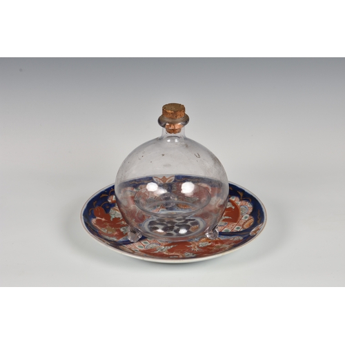 171 - A 19th century blown glass fly or wasp trap, of typical form with cork stopper, 6¼in. (15.8cm.) high... 