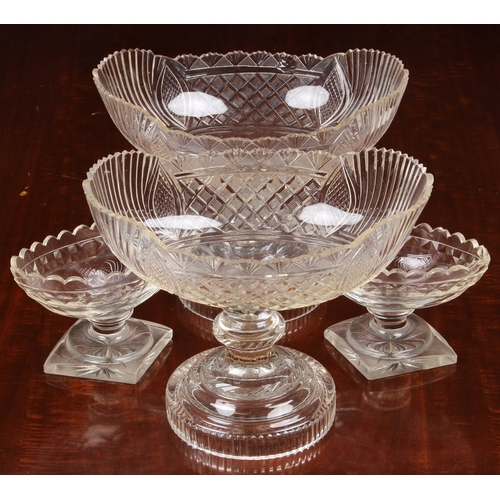 174 - A pair of Georgian cut glass navette pedestal dishes, on knopped stems and raised on round stepped b... 