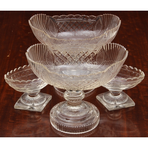 174 - A pair of Georgian cut glass navette pedestal dishes, on knopped stems and raised on round stepped b... 