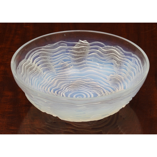 178 - A Lalique opaline glass 'Dauphins' bowl, with multiple species of impressed fish, swimming among spi... 