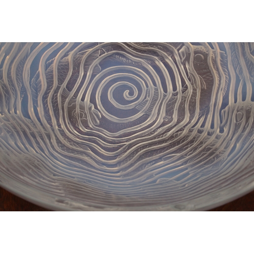 178 - A Lalique opaline glass 'Dauphins' bowl, with multiple species of impressed fish, swimming among spi... 