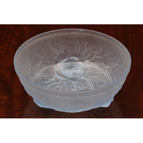 179 - A blue frosted glass bowl in the style of Lalique, with raised decoration of leaves and stems and th... 