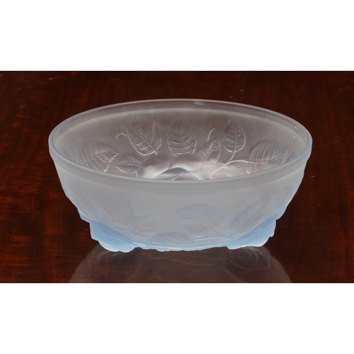 179 - A blue frosted glass bowl in the style of Lalique, with raised decoration of leaves and stems and th... 