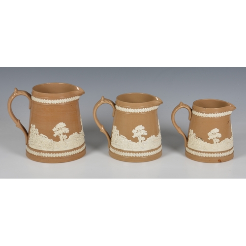 22 - Three Victorian Copeland Late Spode graduated jugs, buff stoneware with sprigged relief decoration o... 