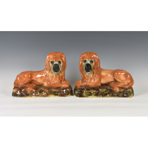 27 - A pair of antique Scottish Bo'ness Pottery recumbent lions, mantel/fireside ornaments, 13in. (33cm.)... 