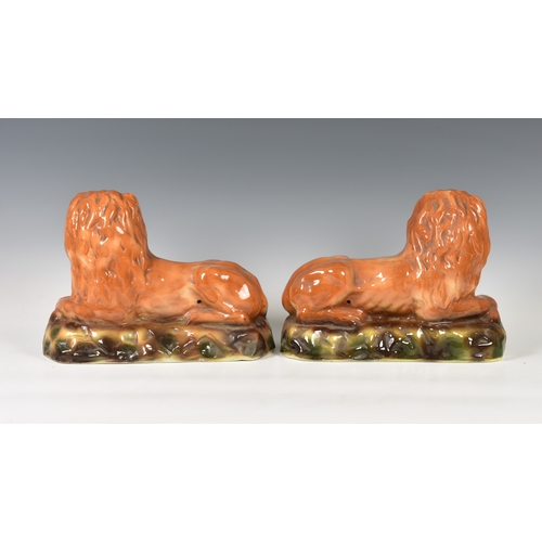 27 - A pair of antique Scottish Bo'ness Pottery recumbent lions, mantel/fireside ornaments, 13in. (33cm.)... 