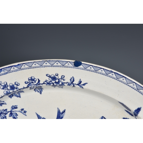 42 - An early 19th century large blue and white pottery meat platter, printed with 'Wild Rose' pattern, 2... 