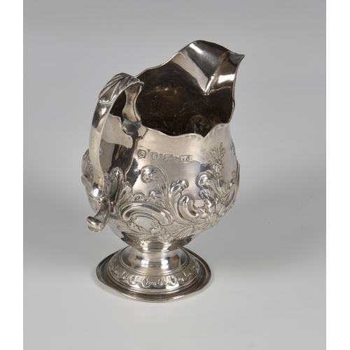 438 - A late-George II silver pedestal cream jug, Walter Brind, London 1758, of bellied form with cut card... 