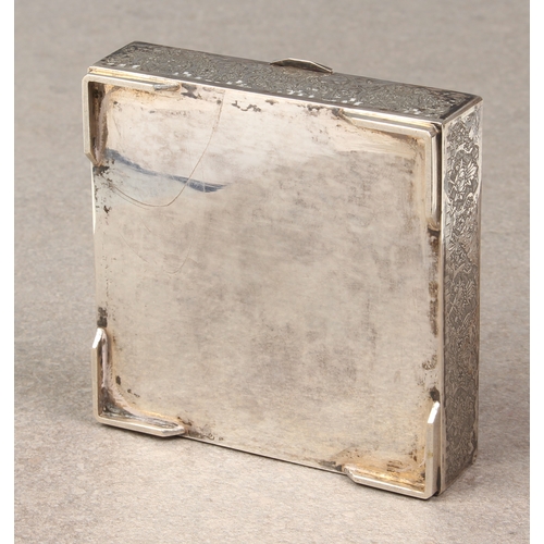 449 - A Persian silver lidded box, probably early 20th century, of square form, chased with a large floral... 