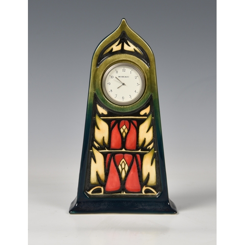 55 - A Moorcroft mantel clock, in black glaze with red, cream and green stylised decoration, marked benea... 