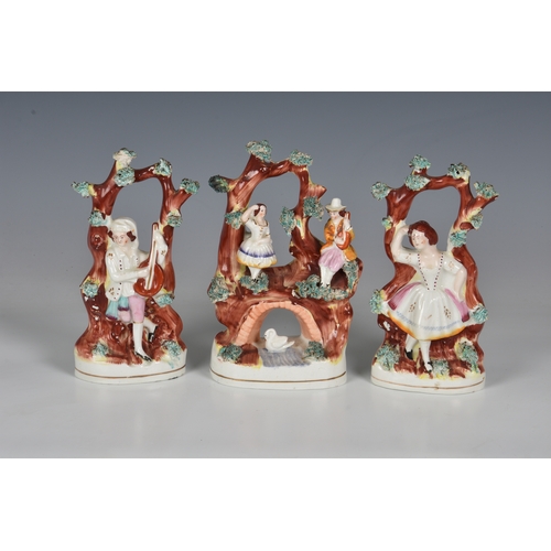 64 - A Staffordshire figural group, mid 19th century, of a couple above an arched bridge with a swan bene... 