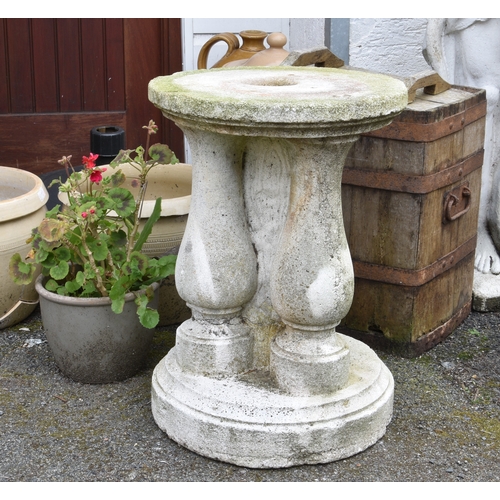 751 - A composite stone plinth, of circular form with three integral baluster columns, 23in. (58.5cm.) hig... 