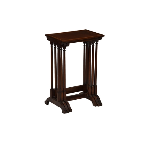 775 - An Edwardian mahogany nest of tables, the crossbanded ebony and boxwood strung tops over slender tur... 