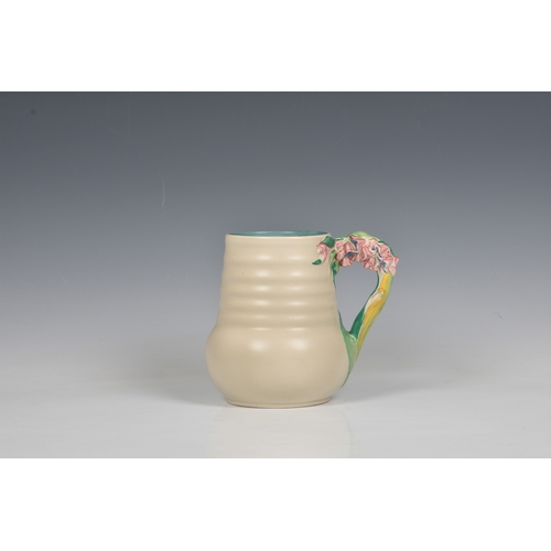 78 - A Clarice Cliff jug, c.1936, moulded floral, leaf and stem handle, ribbed body, printed Newport Pott... 