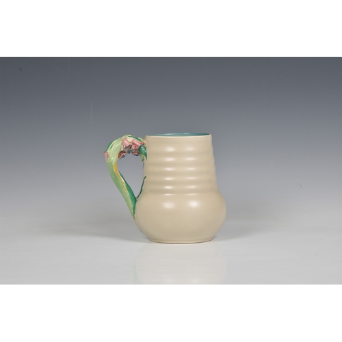 78 - A Clarice Cliff jug, c.1936, moulded floral, leaf and stem handle, ribbed body, printed Newport Pott... 