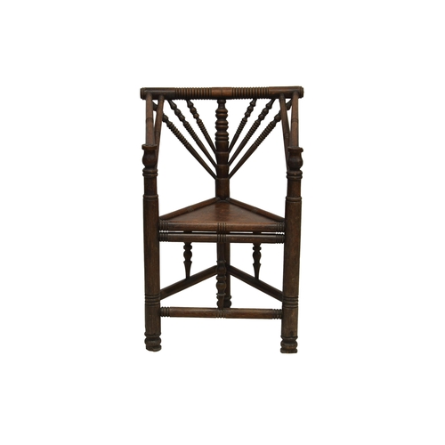 781 - An early 19th century oak turner's chair, height to seat 18¾in. (47.6cm.).