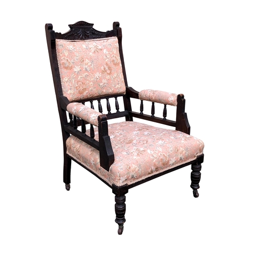 799 - An Edwardian carved and stained walnut open armchair, the square, padded spindle back with shaped fo... 