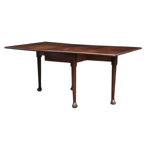 803 - A George III mahogany drop flap dining table, the rectangular top with deep drop flaps, raised on tu... 