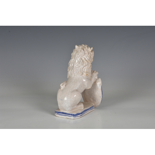 82 - A French faience figure of an armorial lion, probably early 20th century, the seated, white glazed l... 