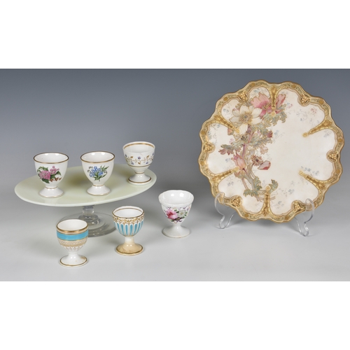 91 - Six 19th century porcelain egg cups, including a moulded Coalport egg cup with painted floral spray ... 