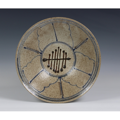 99 - Peter Arnold for Alderney Pottery, a late 20th century studio pottery footed bowl, in a mottled buff... 