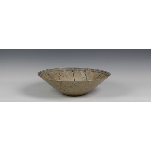 99 - Peter Arnold for Alderney Pottery, a late 20th century studio pottery footed bowl, in a mottled buff... 