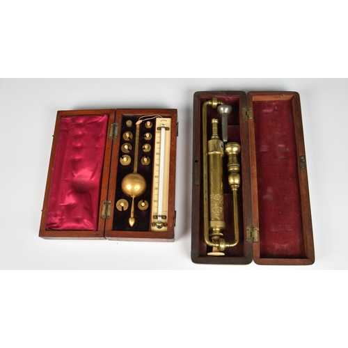 1462 - A Sikes hydrometer in fitted case, together with a cased Surgical brass pump. (2)