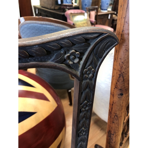 804 - A pair of 19th century Anglo-Indian carved hardwood open armchairs, possibly padouk wood, carved wit... 