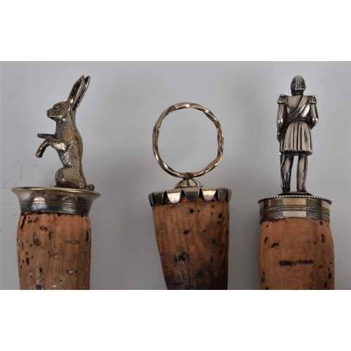 927 - Three silver plate wine bottle stoppers to include a hare on hind legs, admiral / soldier, 4 1/8in. ... 