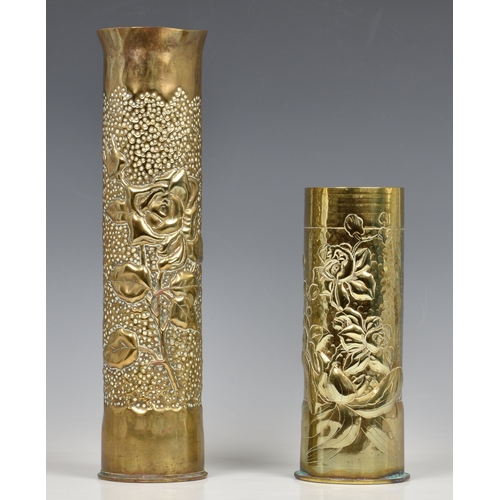 928 - Two Trench Art brass shell vases both beaten with raised flower decoration, the tallest 13 ¾in. (34.... 