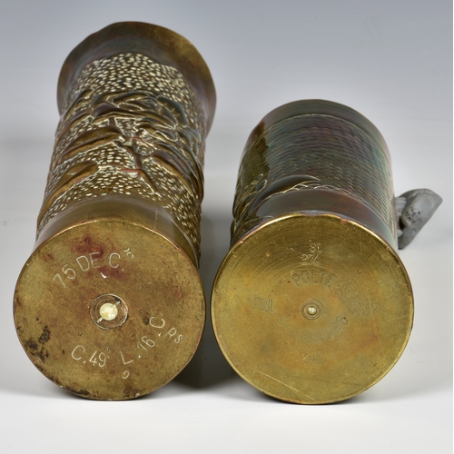 928 - Two Trench Art brass shell vases both beaten with raised flower decoration, the tallest 13 ¾in. (34.... 