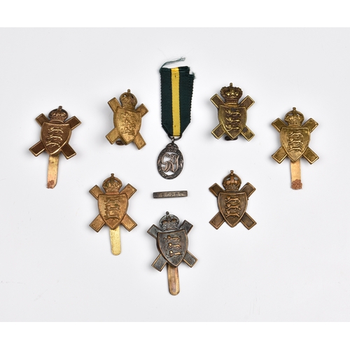 932 - Assorted Jersey Militia cap badges with a Jersey Militia dress medal and seven badges. * Provenance:... 