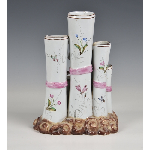 11 - An antique French Faience pottery vase  with six flower holders, applied and hand painted floral dec... 