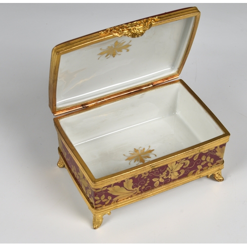 27 - A Limoges porcelain casket with domed lid and gilt metal mounts  hand painted and gilded decoration ... 
