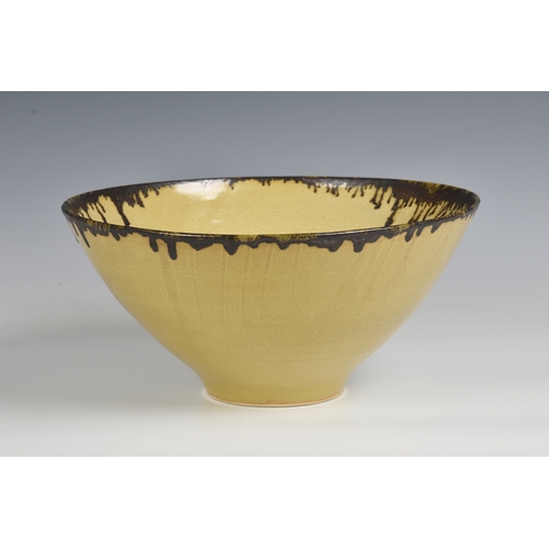 3 - A studio pottery bowl in the manner of Dame Lucie Rie  the flared, footed stoneware bowl in a mottle... 