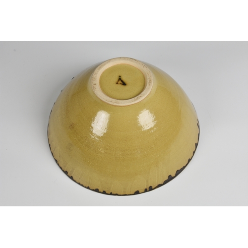 3 - A studio pottery bowl in the manner of Dame Lucie Rie  the flared, footed stoneware bowl in a mottle... 