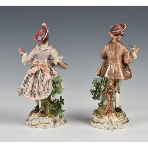 32 - A pair of Wessel, Frankenthal porcelain figures,  of a woman holding a rose and a man with a bird in... 