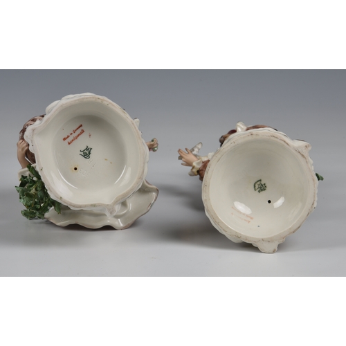 32 - A pair of Wessel, Frankenthal porcelain figures,  of a woman holding a rose and a man with a bird in... 