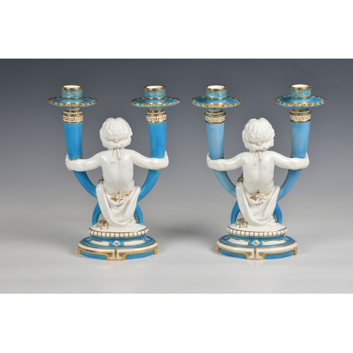 54 - A pair of Minton twin branch candelabras  of a central Cherub holding on each hand an outswept candl... 